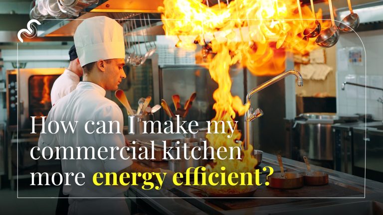 Professional chef flambéing a dish in a restaurant kitchen.
