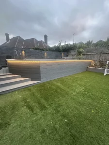 Outdoor swimming pool in a garden illuminated with lights