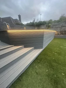 Outdoor swimming pool in a garden illuminated with lights