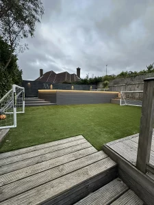 Garden swimming pool lit up with ambient lighting.