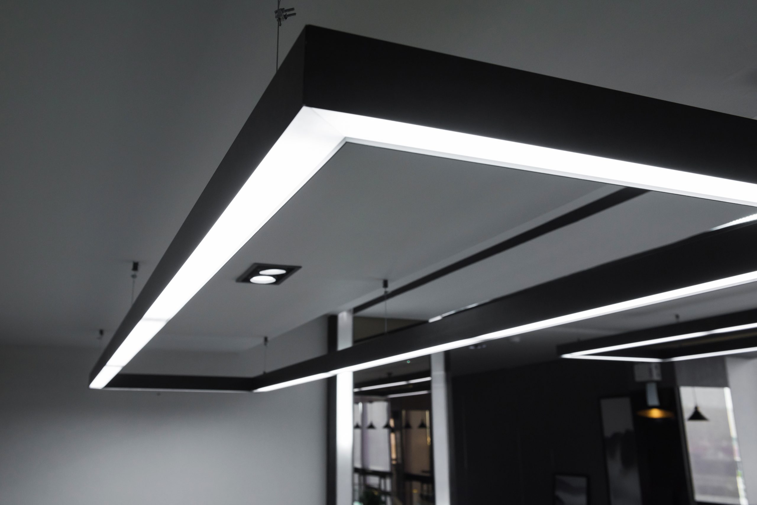 LED white cold light over workplaces. Modern office lighting.