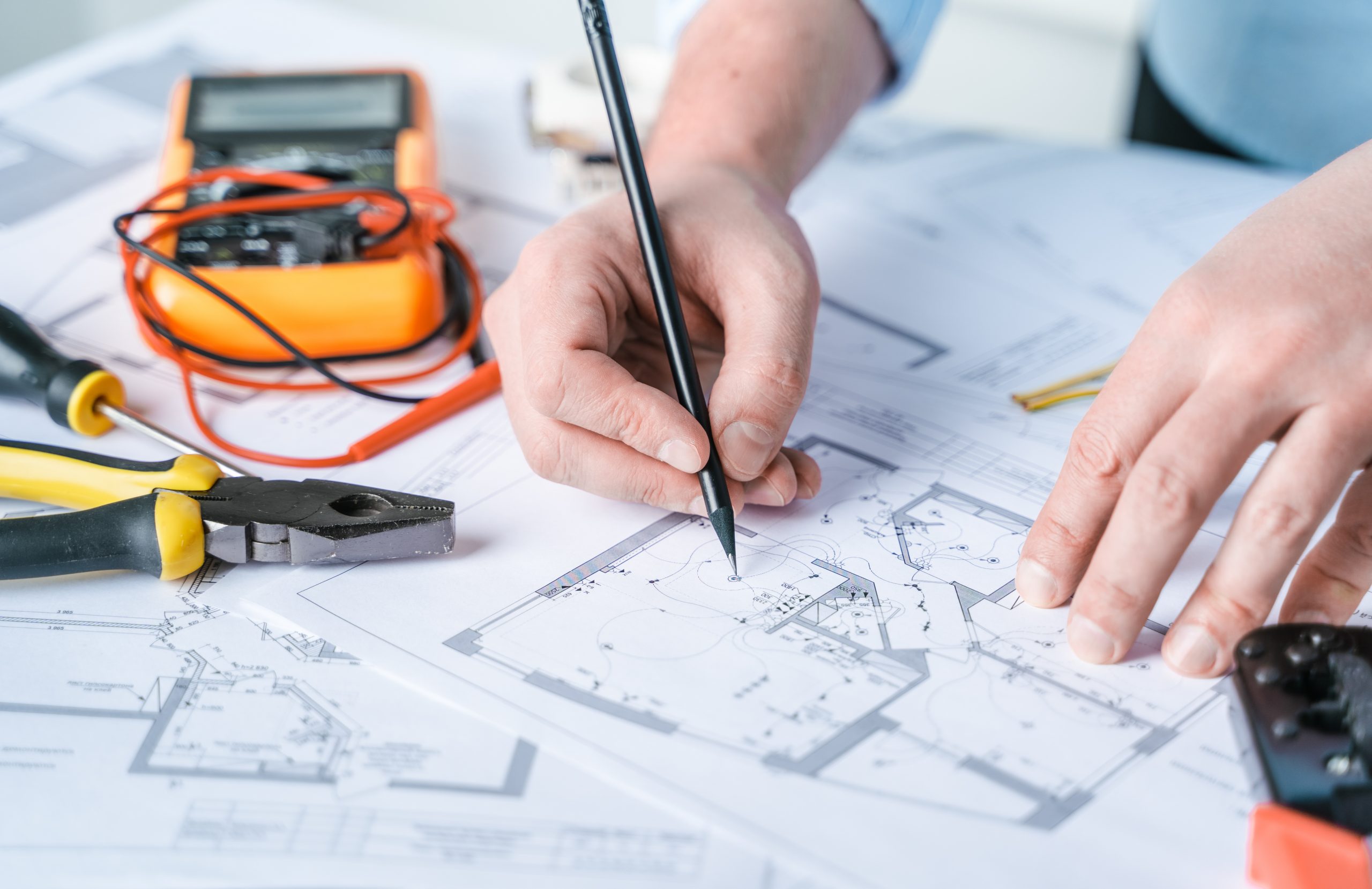 Man repairer designing electricity project in house.