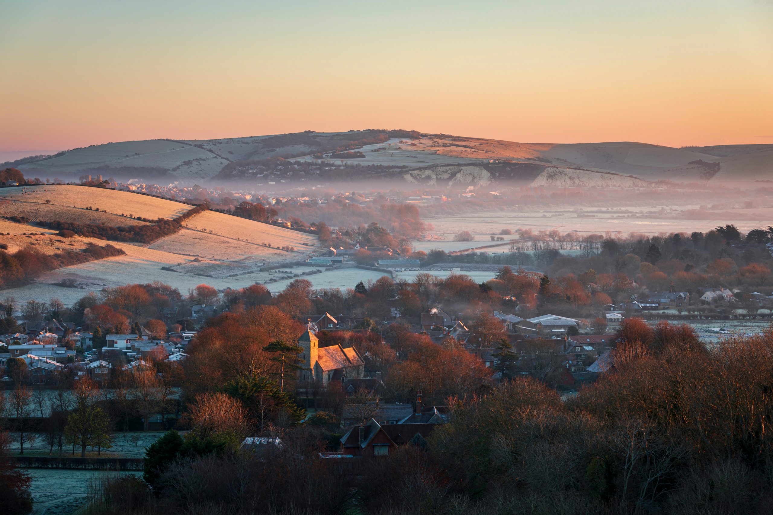 Kingston near Lewes St Pancras church catching the sunrise on a frosty December morning from Kingston Ridge south downs east Sussex south east England