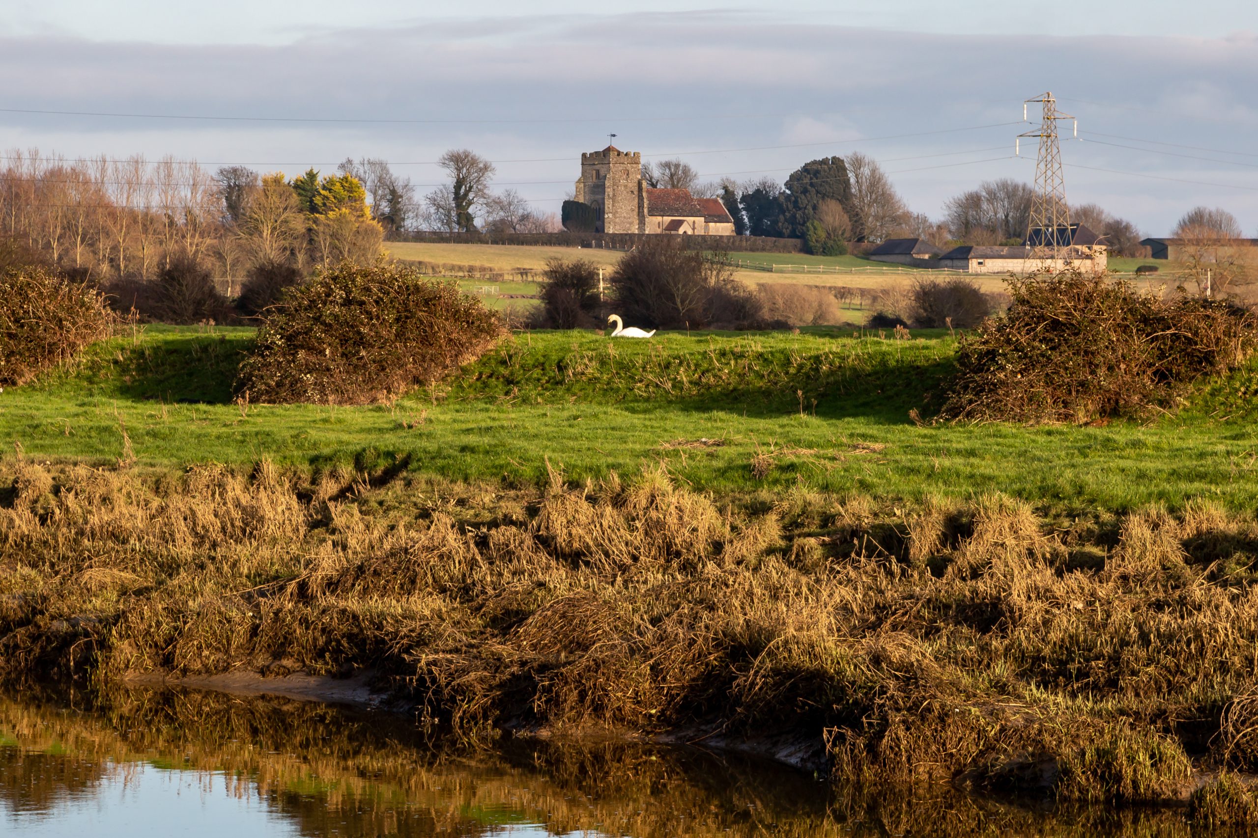 A view over the countryside towards Hamsey Church in Sussex, on a sunny winter's day