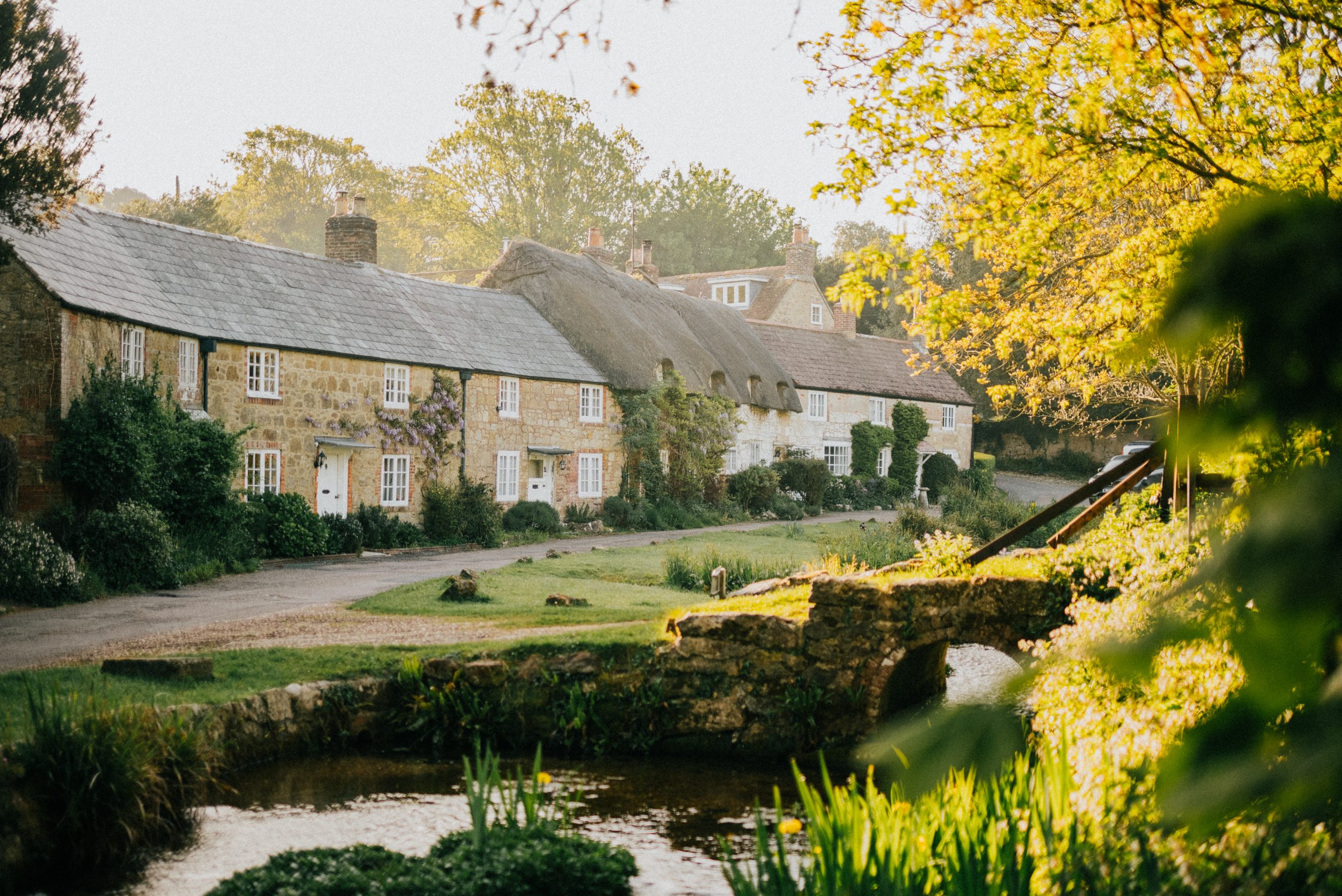 A small town with a bridge over a river and houses on either side