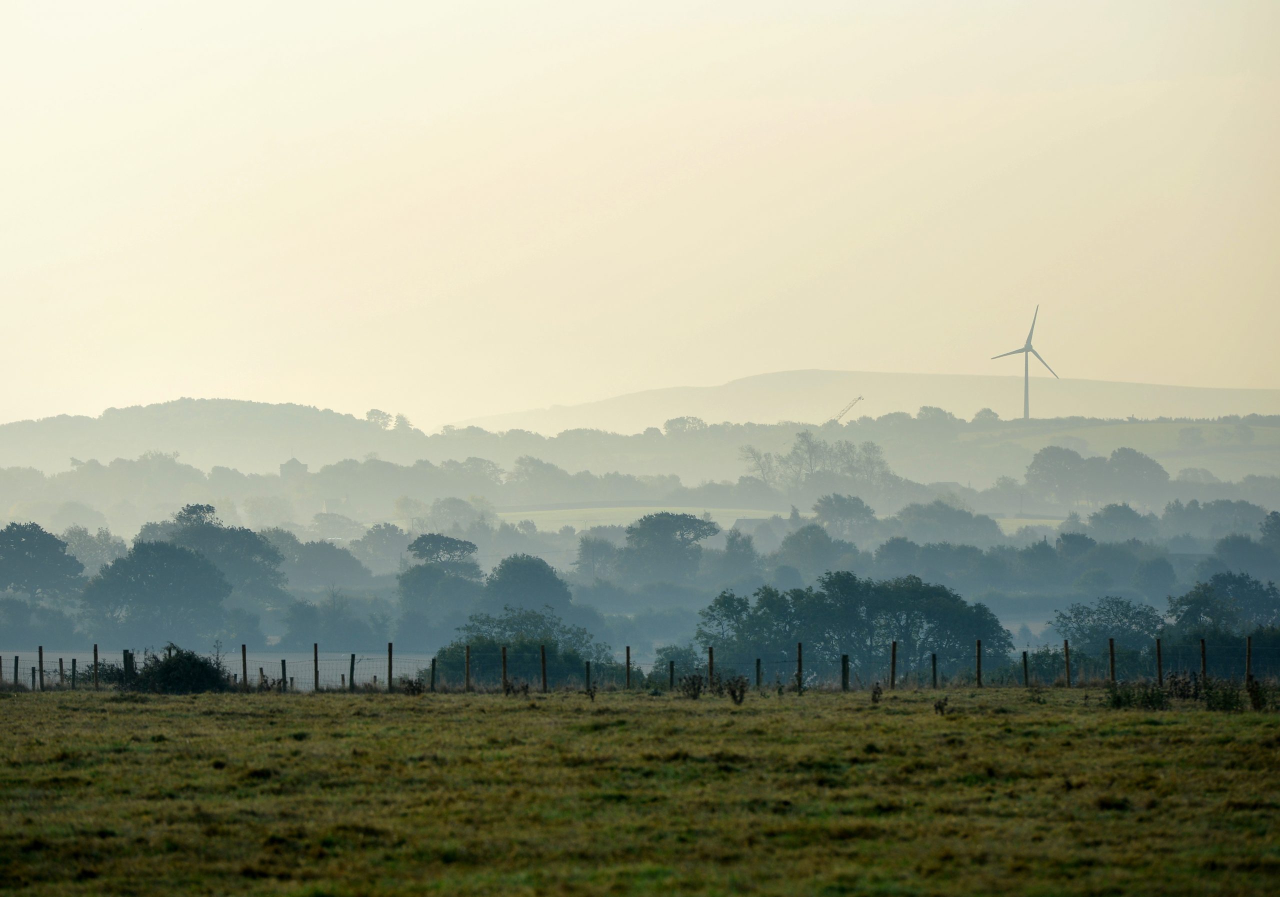 Morning mist at Ringmer, showing church and Glyndebourne wind turbine.